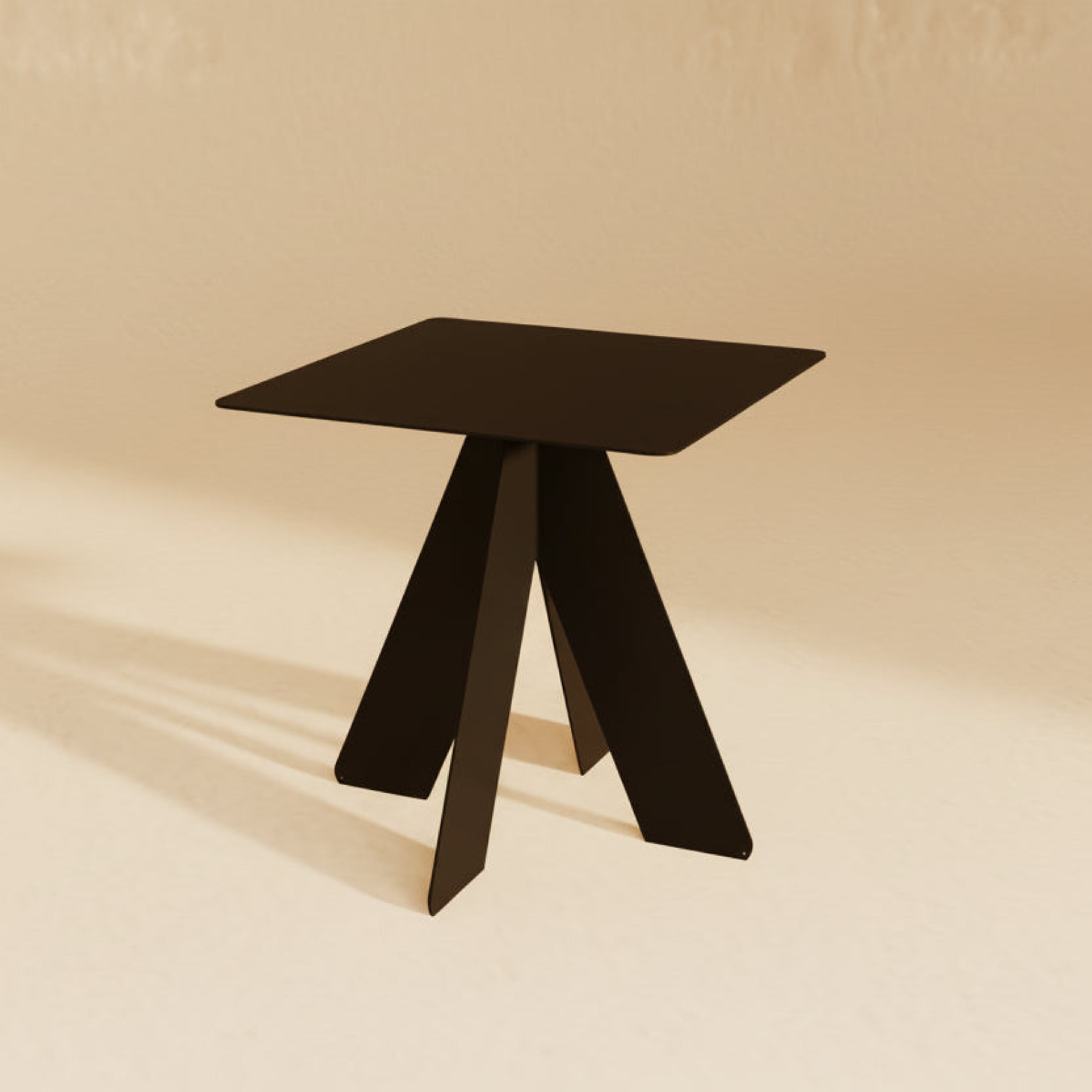 KVADRAT este o măsuță metalică cu design sculptural, definită de un blat pătrat și o bază compusă din patru planuri intersectate.